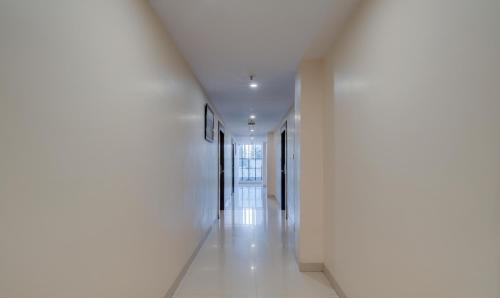 a hallway of a building with white walls and white floors at Treebo MVP Grand in Visakhapatnam