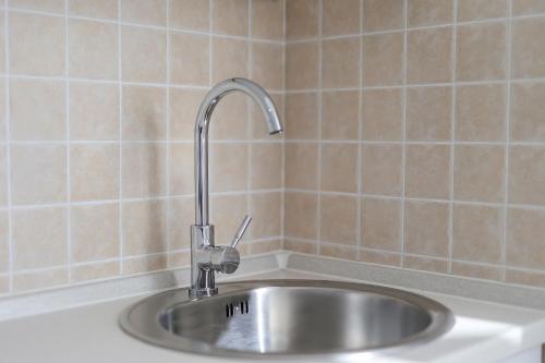 a kitchen sink with a faucet on top of it at Sea view by Moro in Malinska