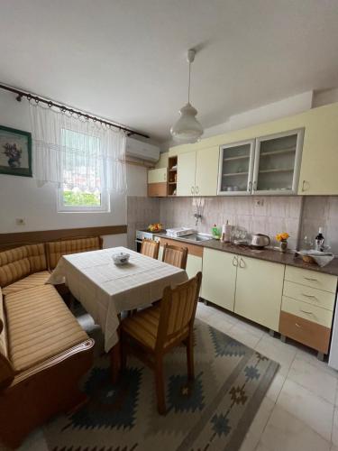 cocina con mesa, mesa y sillas en Apartment Bacio en Petrovac na Moru