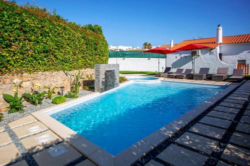 a swimming pool in front of a house at LOTUS VILLA 2, ALBUFEIRA in Albufeira
