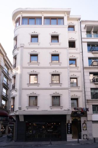 a tall white building with many windows at Felicity Hotel İstanbul in Istanbul