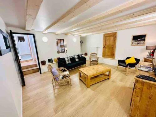 a living room with a couch and a table at Chalet familial de village en Savoie in Peisey-Nancroix