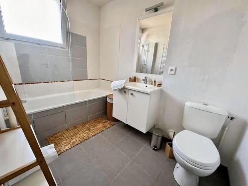 uma casa de banho com um WC, uma banheira e um lavatório. em Relaxation & Business - Villa T3 near MEETT/Airbus em Aussonne