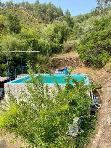 a swimming pool in the middle of a hill at Giant Canvas Rental Tent Agro-turismo Quinta da Fonte in Figueiró dos Vinhos