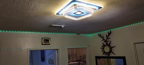 a light on a ceiling with green lights at Two-Bedroom at San Remo Oasis in Cebu City