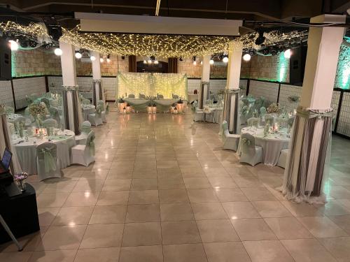 a banquet hall with white tables and chairs at Boutique Hotel & Event Center in Budapest