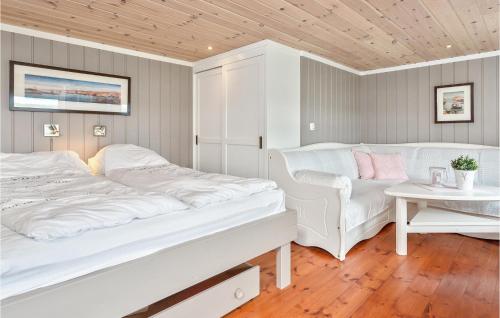 a white bedroom with two beds and a table at Gorgeous Home In Berger With House Sea View in Svelvik