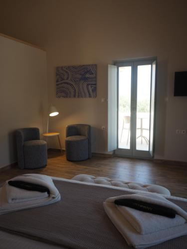 a bedroom with a bed with towels on it at Terra Di Pietra Exclusive Suites & Apartments in Areopolis