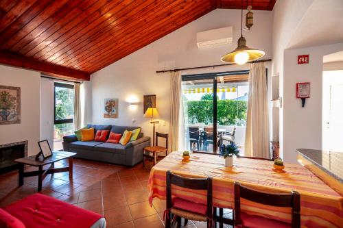 a living room with a table and a couch at LOTUS VILLA 2, ALBUFEIRA in Albufeira