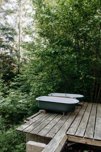 a bath tub sitting on top of a wooden deck at Mountain Lodge Azzy, surrounded by Ultimate Peace! in Valašské Klobouky