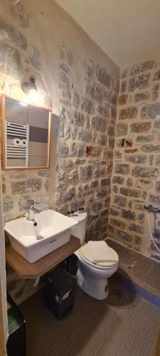 a bathroom with a sink and a toilet at Althea Village in Pyrgos Dirou