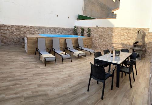 a restaurant with tables and chairs in a room at Villa Jara 25 in Nerja