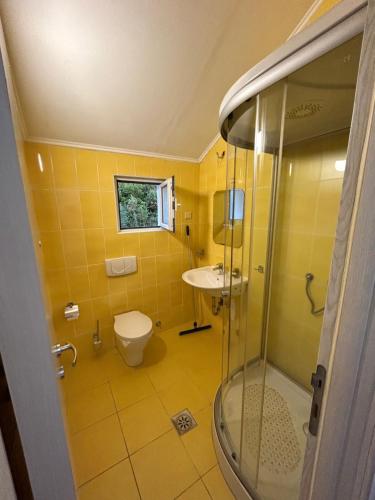 a bathroom with a shower and a toilet and a sink at Krašići apartmani Bozic in Krašići