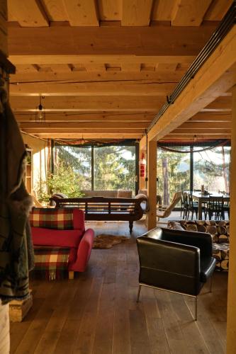 a living room with a red couch and chairs at Mountain Lodge Azzy, surrounded by Ultimate Peace! in Valašské Klobouky