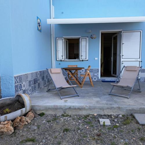 two chairs and a table on a patio at Casa Acquamarina in Marina di Monasterace