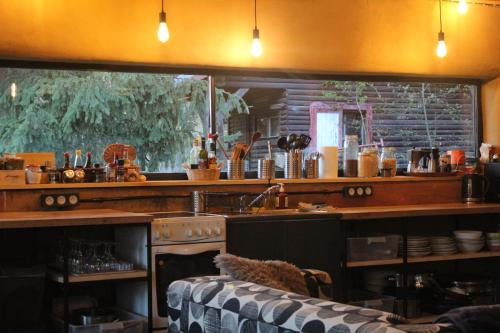 a kitchen with a counter and a sink and a stove at Mountain Lodge Azzy, surrounded by Ultimate Peace! in Valašské Klobouky