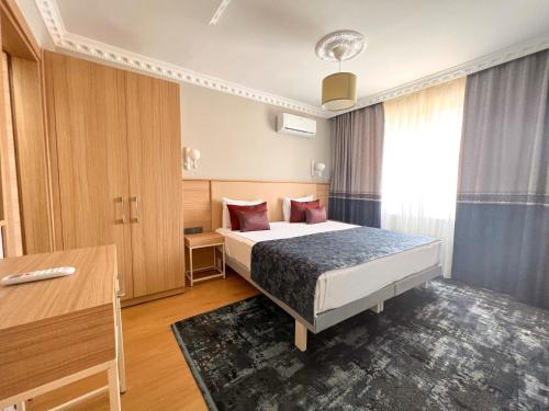 a hotel room with a bed and a desk at Old Town Point Hotel & Spa Antalya in Antalya