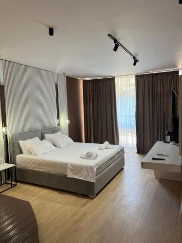 a bedroom with a bed and a television in it at Capital Suites Center in Tirana