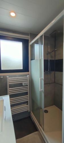 a bathroom with a shower with a glass door at Aux Passagers de la Baie in Le Crotoy