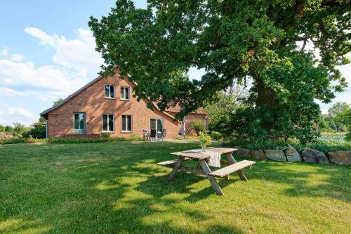 a picnic table in the grass in front of a house at Ferienhaus Mein Stall in Borken