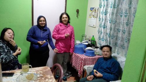a group of people standing in a room at International Youth Hostel and Homestay Kurseong Bazar in Kurseong