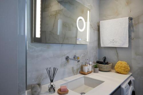 a bathroom with a sink and a mirror at Azura Aqua Foinikas in Finikas