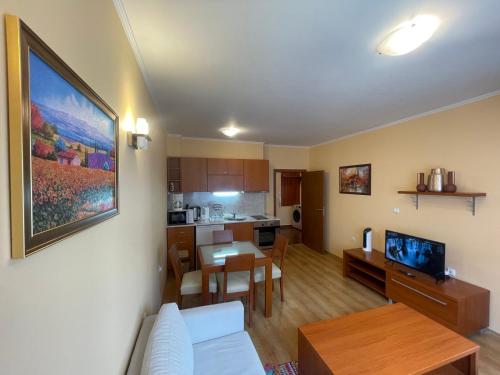 a living room and kitchen with a couch and a table at Ski-in ski-out Fantastic Apartament in Bansko