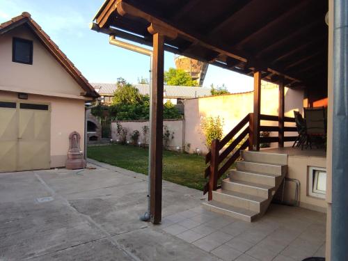 a patio with stairs and a wooden pergola at Kuća za odmor KOD MARE in Vukovar