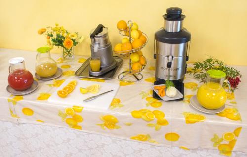a table with a coffee maker and fruit on it at Cà Del Moro Resort & SPA in Pontremoli