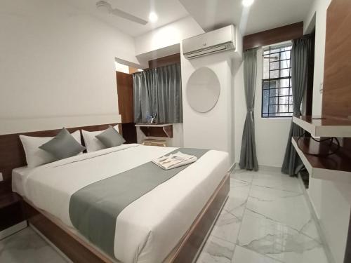 a bedroom with a large bed in a room at Royal N Deluxe in Bangalore