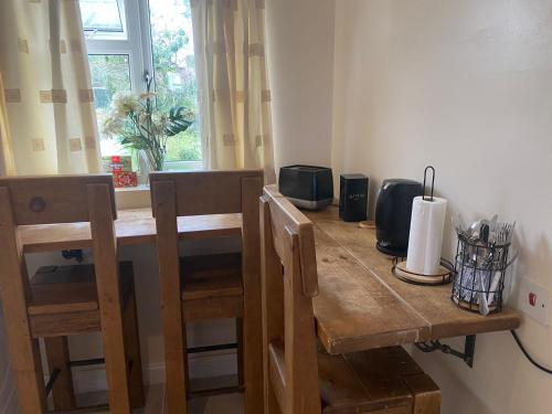a wooden table with two chairs and a window at Rainbow in London