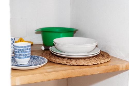 a wooden shelf with bowls and plates on it at Estudio I ideal para parejas en la playa Alguer in L'Ametlla de Mar