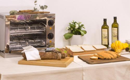 a table with cheese and bread and bottles of wine at Cà Del Moro Resort & SPA in Pontremoli