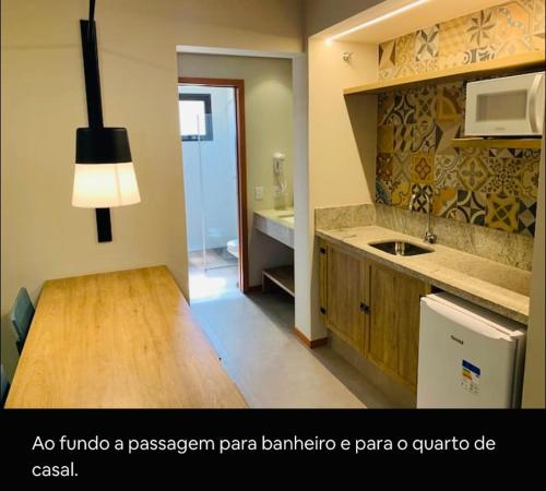 a kitchen with a sink and a counter top at Quinta Santa Bárbara Pirenópolis in Pirenópolis