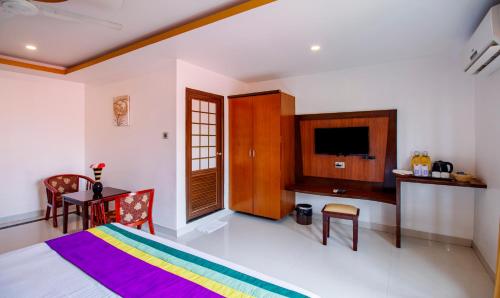 Treebo Premium Palmyra Milford, 2 Km From Alleppey Beachにあるテレビまたはエンターテインメントセンター