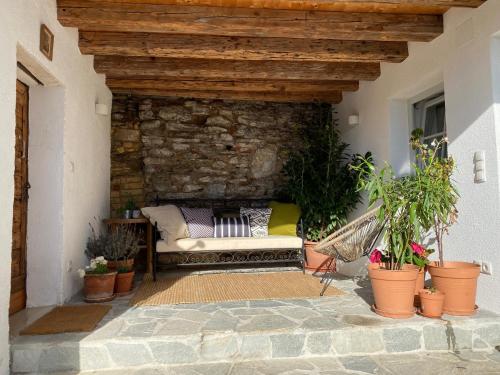 a patio with a couch and a stone wall at kremsoase in Krems an der Donau