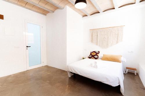 Ένα ή περισσότερα κρεβάτια σε δωμάτιο στο Estudio II ideal para parejas en la playa Alguer