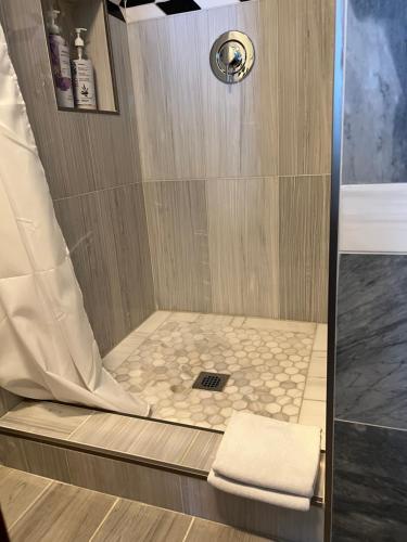 a shower with a white towel in a bathroom at Airport room 33 in Boston