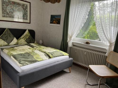 a bedroom with a bed and a window at Ferienwohnung Wegener in Neetze