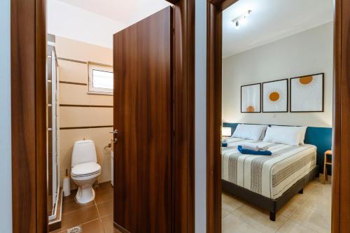 Postel nebo postele na pokoji v ubytování Harmony Apartments