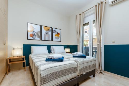 a bedroom with a large bed with blue walls at Harmony Apartments in Kato Daratso