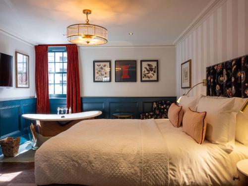 a bedroom with a large bed and a table at Spread Eagle in London
