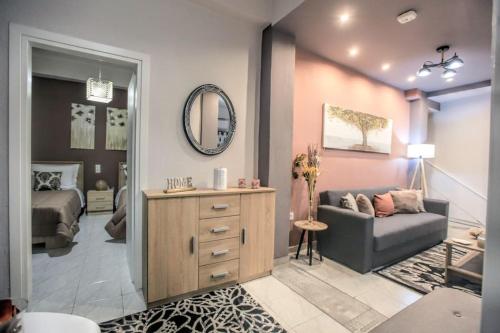a living room with a couch and a mirror at Dreamy cozy house.. in Kalabaka