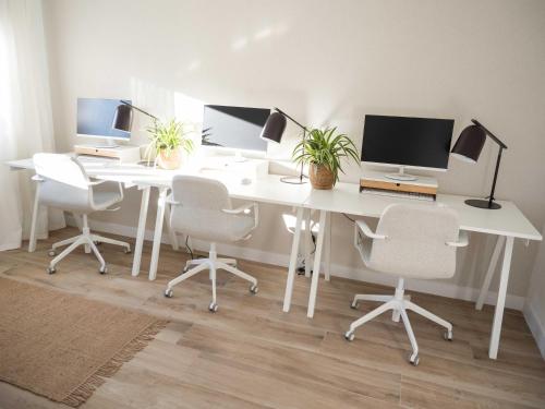 a white desk with three chairs and a computer on it at Luxury Apartment in Valencia City center in Valencia