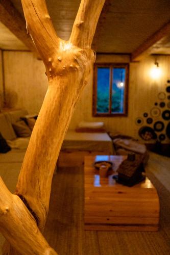 a wooden cross in a living room with a table at Cabana La Cuib Sovata in Sovata