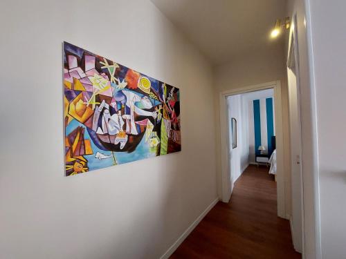 a painting hanging on a wall in a hallway at Sicily Holidays Home in Calatabiano