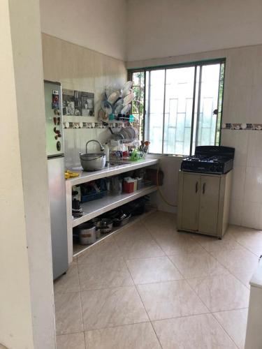 a kitchen with a refrigerator and a counter in it at Hermosa Finca de descanso en Villa Samaria a 35 minutos de Melgar in Melgar