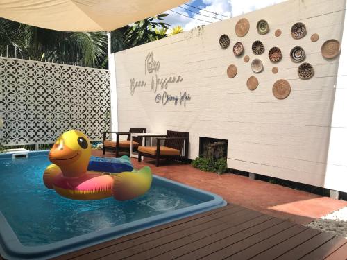 a pool with a rubber duck in a swimming pool at Baan Wassana In The City Old Moat in Chiang Mai
