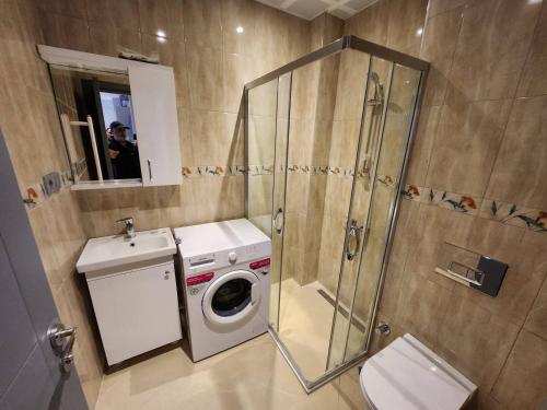 a bathroom with a washing machine and a shower at Remta Real Estate in Istanbul