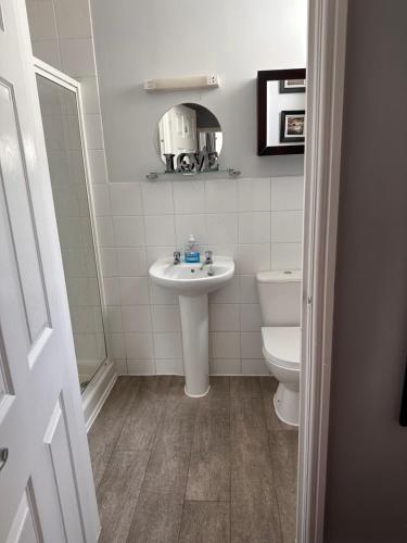 a bathroom with a sink and a toilet at Berkswell Holiday Apartments in Blackpool